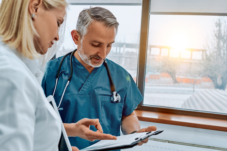 Two eye doctors or surgeons look at a clipboard at Specialized Surgical Center of Central New Jersey